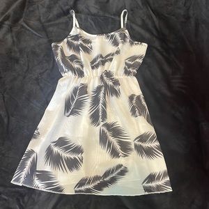 Brand is Shein and it’s white with black Pom leaves